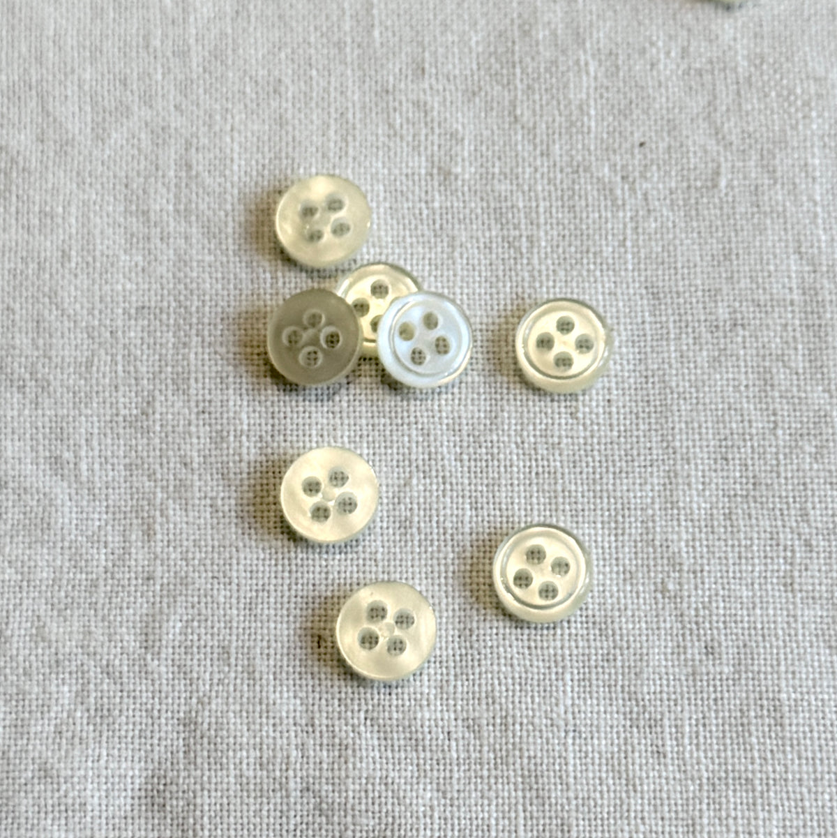 Off white  rimmed 1/3" plastic button