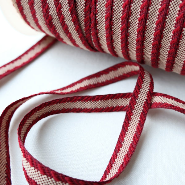 woven red and beige jacquard ribbon