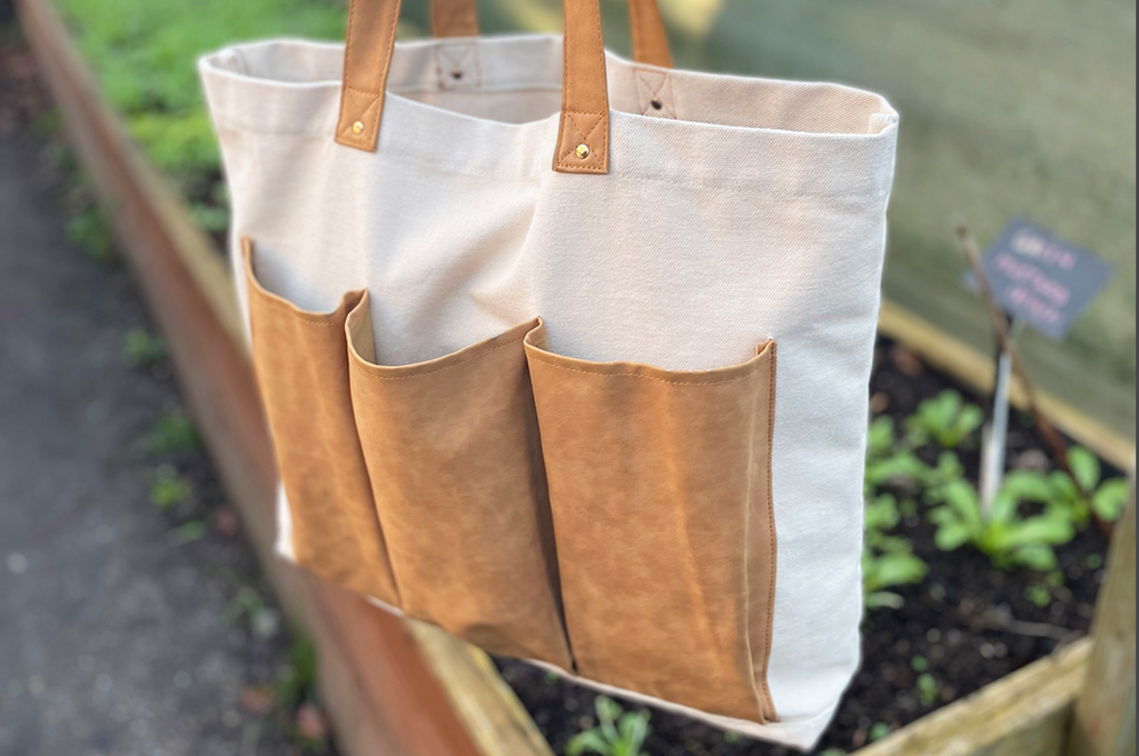 Webbing and leather-trimmed embroidered canvas tote