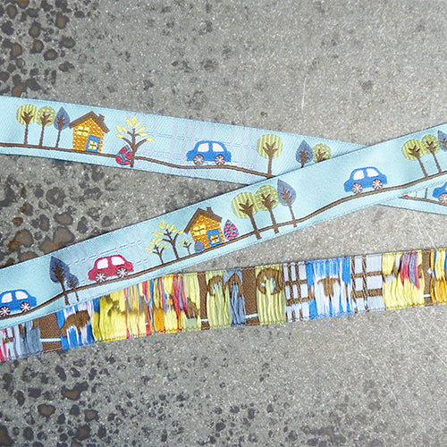 sue spargo ribbon tooting along cars houses blue