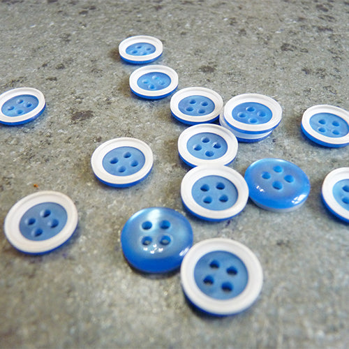 plastic white four hole button white rim on blue