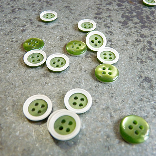 plastic white four hole button white rim on green